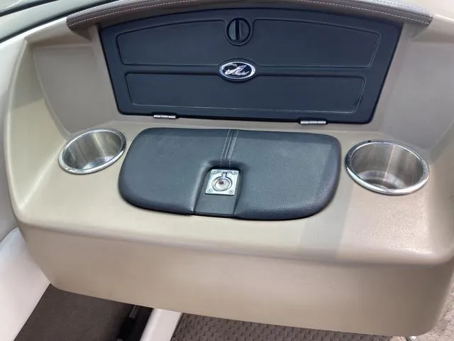 Slide: The Image of 2011 Sea Ray 230 SLX boat interior with cup holders and storage compartments. - 13