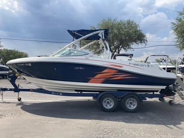 Slide: The Image of 2011 Sea Ray 230 SLX boat on a trailer, blue and white with orange graphics. - 21