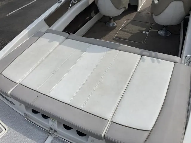 Slide: The Image of 2011 Sea Ray 230 SLX boat interior with cushioned seating and dual captain chairs. - 6