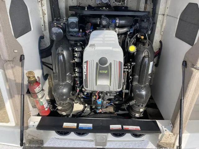 Slide: The Image of 2011 Sea Ray 230 SLX boat engine compartment with fire extinguisher. - 9
