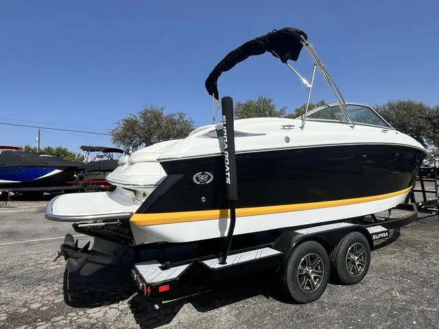 Slide: The Image of 2008 Cobalt 242 boat on a trailer, black and white with yellow stripe. - 10