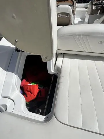Slide: The Image of Open storage compartment on a 2008 Cobalt 242 boat with white seating. - 15