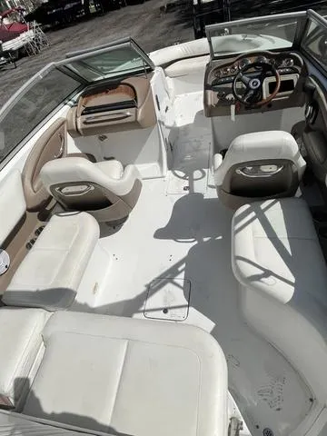 Slide: The Image of 2008 Cobalt 242 boat interior with white and beige seating. - 17