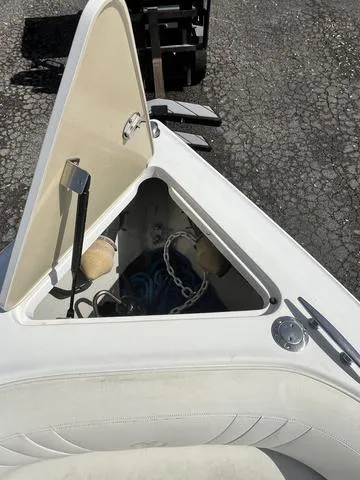 Slide: The Image of Open storage compartment on a 2008 Cobalt 242 boat with anchor and ropes. - 24