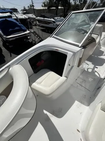 Slide: The Image of 2008 Cobalt 242 boat interior with white seating and open windshield. - 28