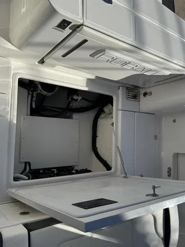 Slide: The Image of 2024 Robalo 360 boat interior compartment with open hatch. - 10