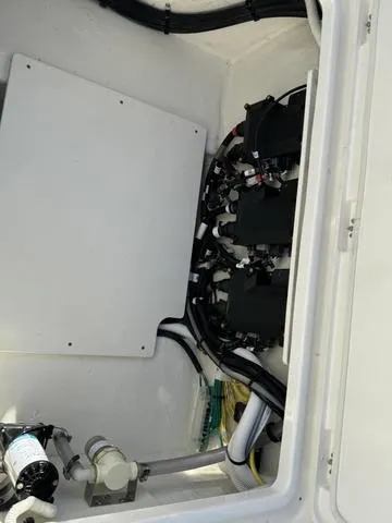 Slide: The Image of 2024 Robalo 360 boat engine compartment with wiring and components. - 11