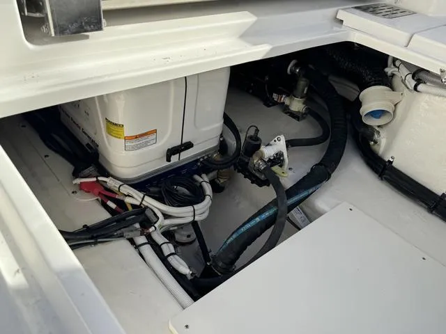 Slide: The Image of 2024 Robalo 360 boat engine compartment with wiring and components. - 12