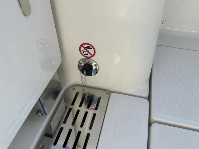 Slide: The Image of 2024 Robalo 360 boat deck with fuel cap and no smoking sign. - 13