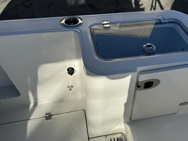 Slide: The Image of 2024 Robalo 360 boat deck with storage compartments and cup holder. - 15