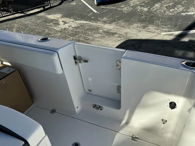 Slide: The Image of 2024 Robalo 360 boat interior, featuring a clean, white deck and storage compartments. - 16