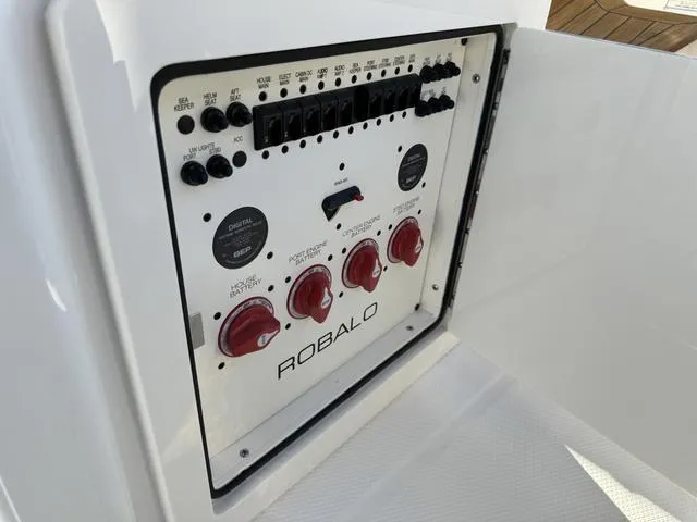 Slide: The Image of Control panel of 2024 Robalo 360 boat with switches and dials. - 24