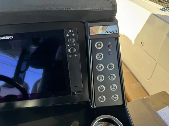 Slide: The Image of Control panel of 2024 Robalo 360 boat with Simrad display and buttons. - 29