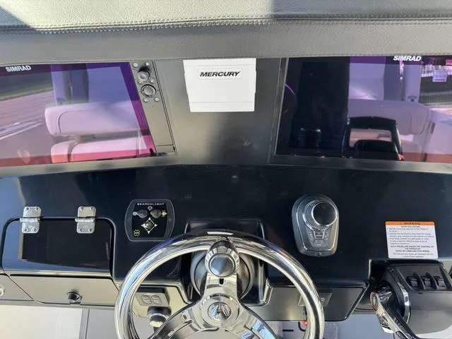 Slide: The Image of Dashboard of 2024 Robalo 360 boat with Simrad displays and Mercury controls. - 31