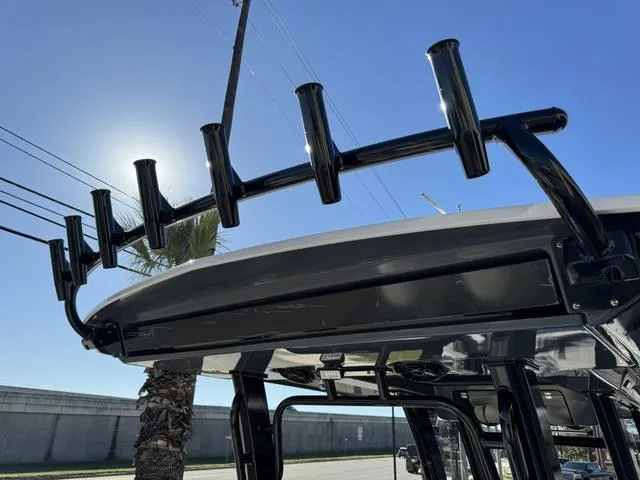 Slide: The Image of 2024 Robalo 360 boat with rod holders under a clear blue sky. - 40