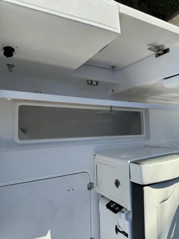 Slide: The Image of 2024 Robalo 360 boat interior storage compartments and seating. - 44
