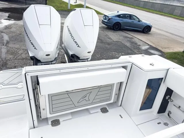 Slide: The Image of 2024 Blackfin 272 CC boat with twin Mercury outboard engines, rear seating, and storage compartments. - 11