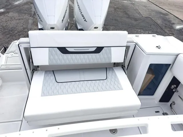 Slide: The Image of 2024 Blackfin 272 CC boat with dual Mercury engines and cushioned seating. - 12