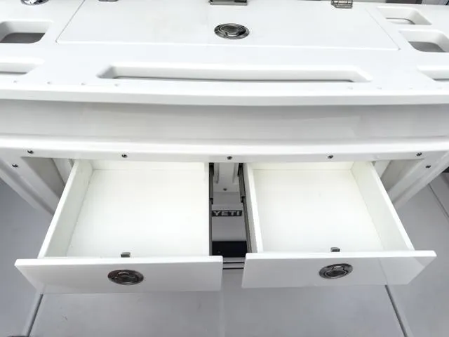 Slide: The Image of 2024 Blackfin 272 CC boat with open storage drawers. - 16