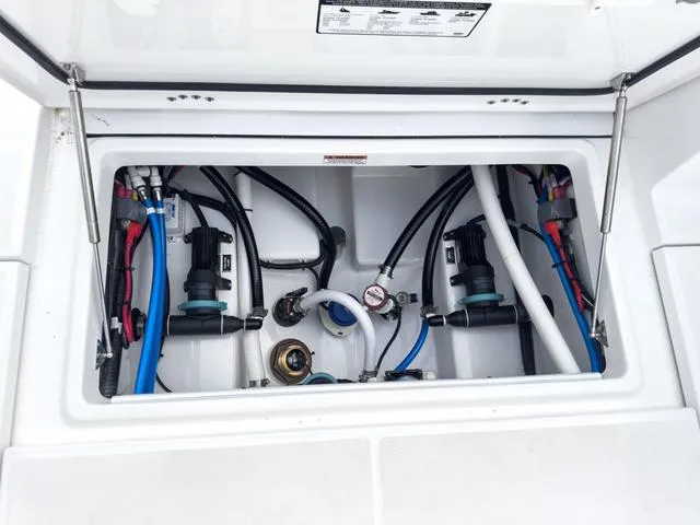 Slide: The Image of 2024 Blackfin 272 CC boat engine compartment with wiring and hoses. - 22