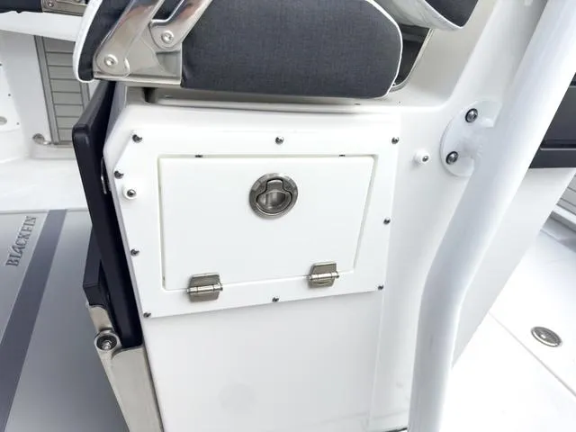 Slide: The Image of 2024 Blackfin 272 CC boat storage compartment and seating detail. - 23
