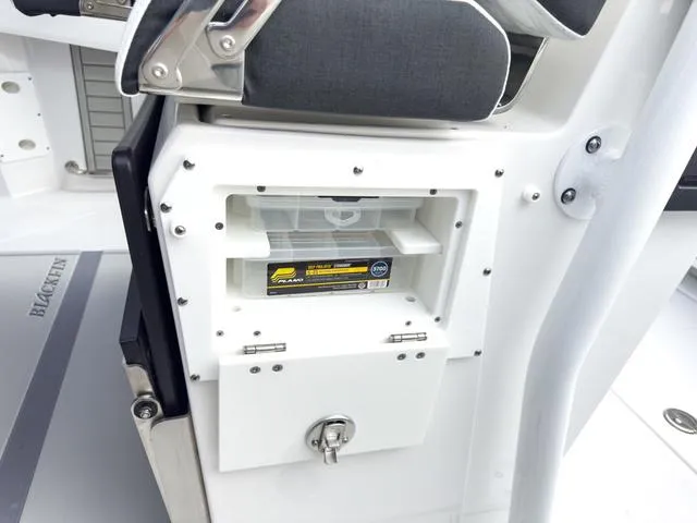 Slide: The Image of 2024 Blackfin 272 CC boat storage compartment with tackle box. - 24