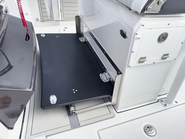 Slide: The Image of 2024 Blackfin 272 CC boat with fold-out table and storage compartments. - 28