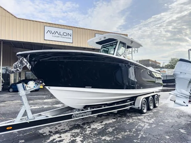 Slide: The Image of 2024 Blackfin 272 CC boat on a trailer at Avalon Luxury Pontoons dealership. - 3