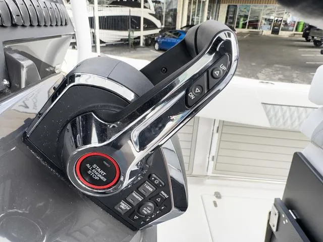 Slide: The Image of Close-up of 2024 Blackfin 272 CC boat throttle controls. - 35