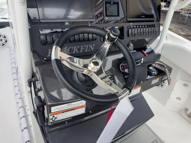 Slide: The Image of 2024 Blackfin 272 CC boat helm with steering wheel and control panel. - 37