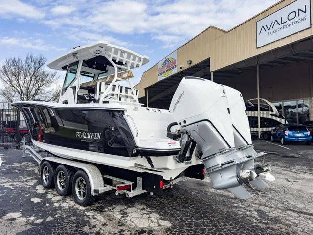 Slide: The Image of 2024 Blackfin 272 CC boat with twin outboard engines on a trailer. - 4