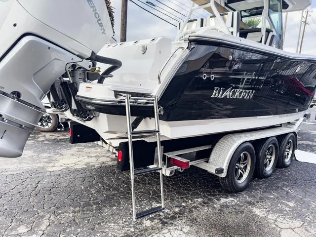 Slide: The Image of 2024 Blackfin 272 CC boat on a trailer with Mercury outboard engines. - 7