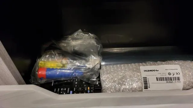 Slide: The Image of Storage compartment in 2023 Formula 380 SSC with tools and packaged items. - 17