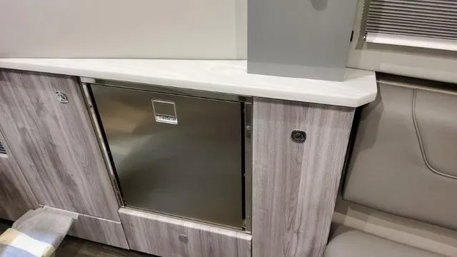 Slide: The Image of Interior of 2023 Formula 380 SSC with stainless steel mini fridge and modern cabinetry. - 26