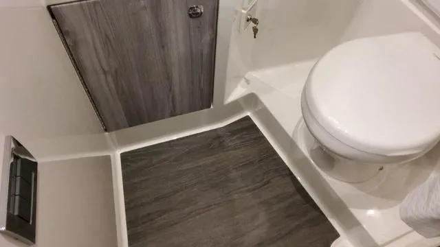 Slide: The Image of 2023 Formula 380 SSC bathroom with modern wood accents and white fixtures. - 28