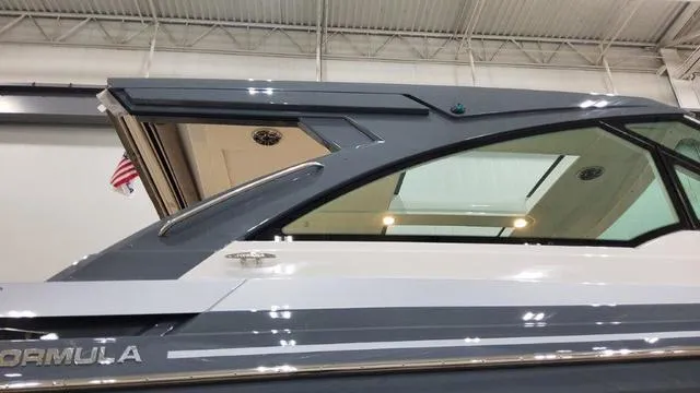 Slide: The Image of 2023 Formula 380 SSC luxury boat side view in a showroom. - 3