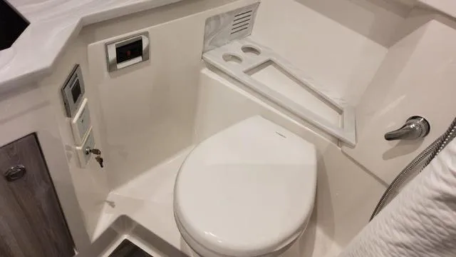 Slide: The Image of 2023 Formula 380 SSC boat bathroom with modern fixtures and white interior. - 31