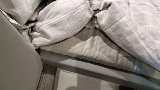 Slide: The Image of Interior bedding of 2023 Formula 380 SSC boat with gray plaid blanket. - 37