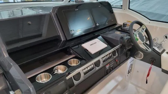 Slide: The Image of 2023 Formula 380 SSC boat dashboard with dual screens and modern controls. - 40