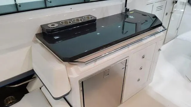 Slide: The Image of 2023 Formula 380 SSC boat interior with sleek countertop and storage cabinets. - 42