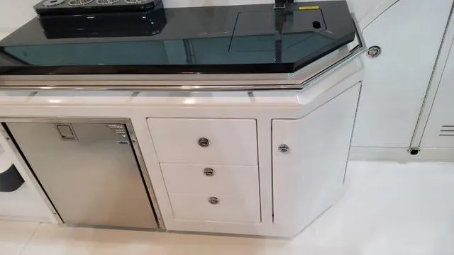 Slide: The Image of 2023 Formula 380 SSC yacht interior kitchen with stainless steel appliances and white cabinetry. - 43