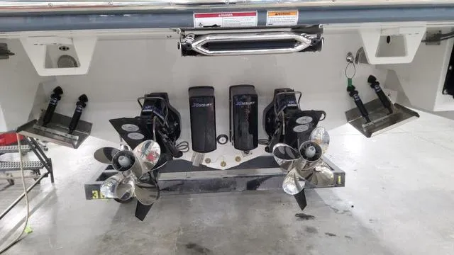 Slide: The Image of 2023 Formula 380 SSC boat stern with dual propellers and trim tabs in a garage. - 7