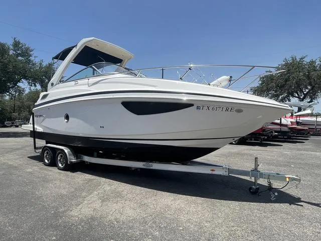 The Image of 2019 Regal 28 Express boat on a trailer in a parking lot. - 1