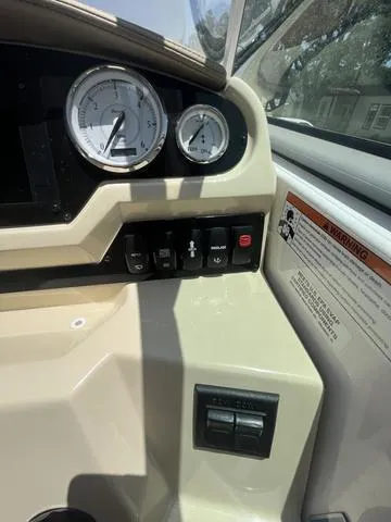 Slide: The Image of Control panel of a 2019 Regal 28 Express boat with gauges and switches. - 13