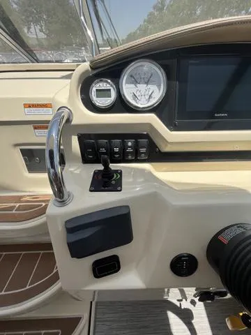 Slide: The Image of 2019 Regal 28 Express boat dashboard with gauges and controls. - 14