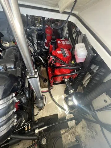 Slide: The Image of Engine compartment of a 2019 Regal 28 Express boat with visible components. - 16