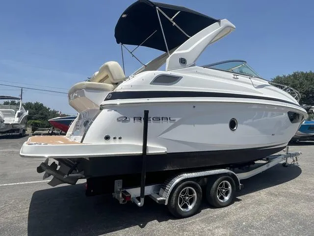 Slide: The Image of 2019 Regal 28 Express boat on a trailer, side view with canopy. - 2