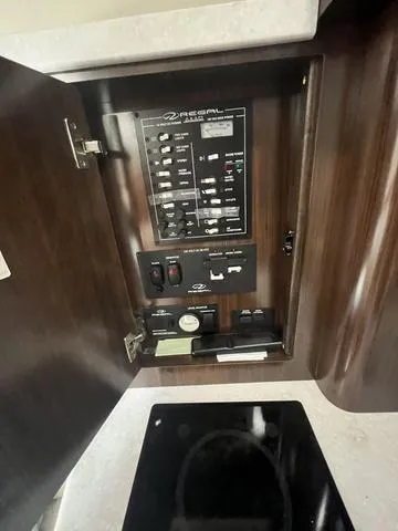 Slide: The Image of Control panel inside a 2019 Regal 28 Express boat. - 23
