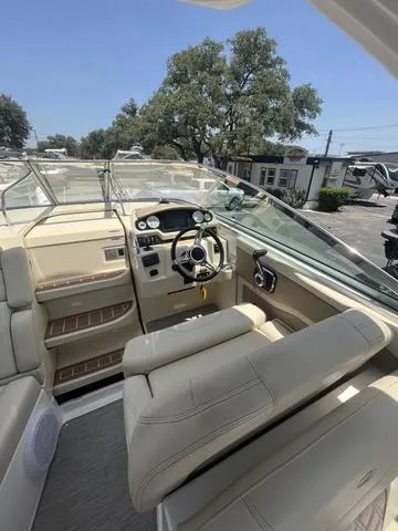 Slide: The Image of 2019 Regal 28 Express boat interior with steering wheel and seating. - 7