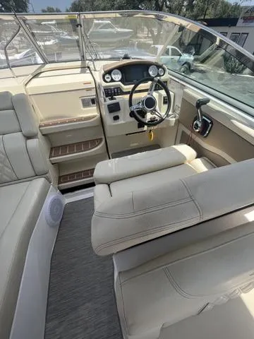 Slide: The Image of 2019 Regal 28 Express boat interior with helm and seating area. - 9